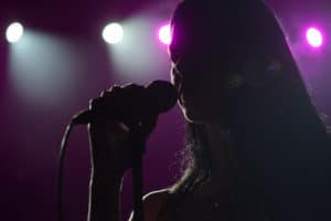 Close Up Image Of Live Singer On Stage. Microphone In Hand at the Kansas City Symphony