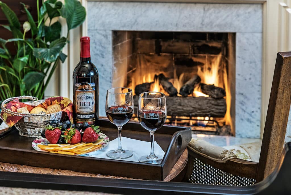 Plan Your Romantic Getaways in Missouri for 2023, photo of our charcuterie board and wine by the fireplace 