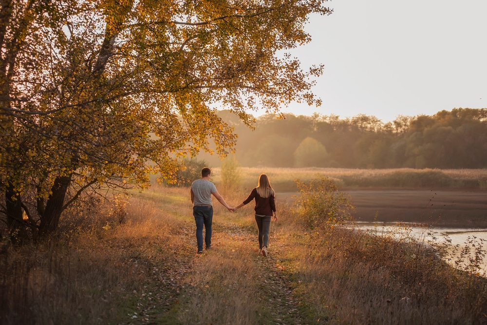 couple walking enjoying the fall foliage near Silver Heart Inn, a unique place to stay in Missouri.